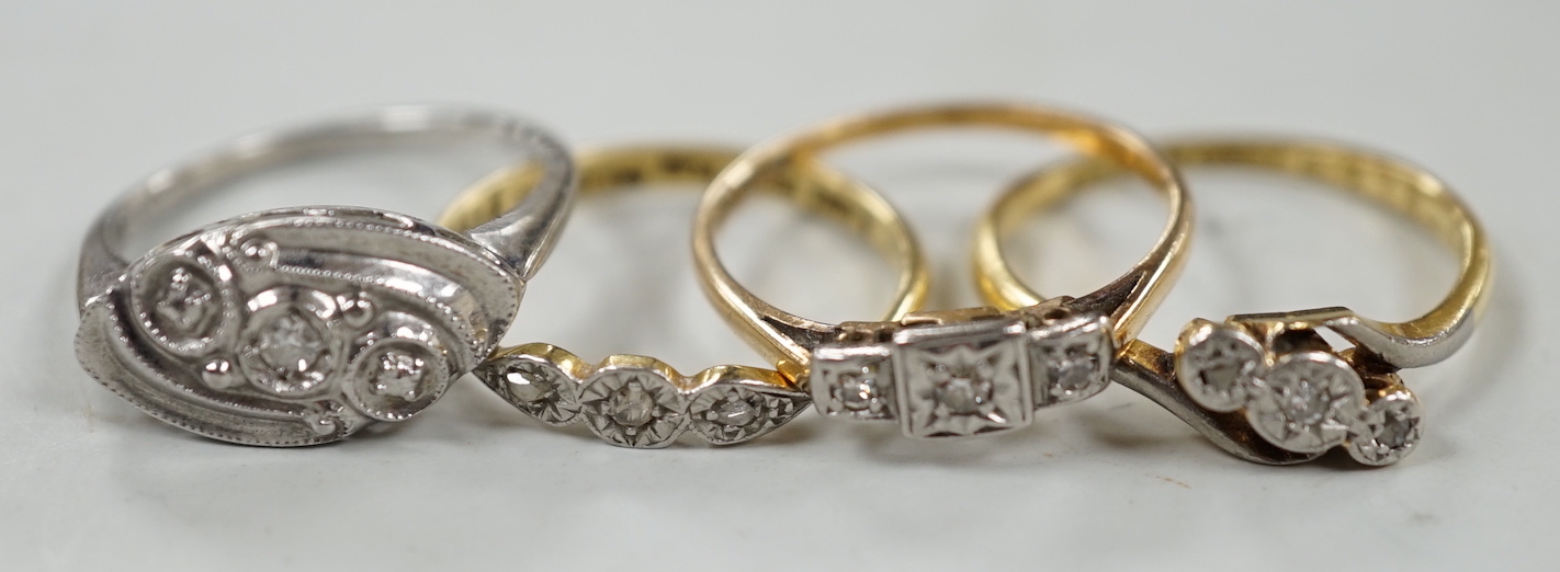 Two 18ct, plat and illusion set three stone diamond rings and two other similar white metal rings, one stamped 9ct